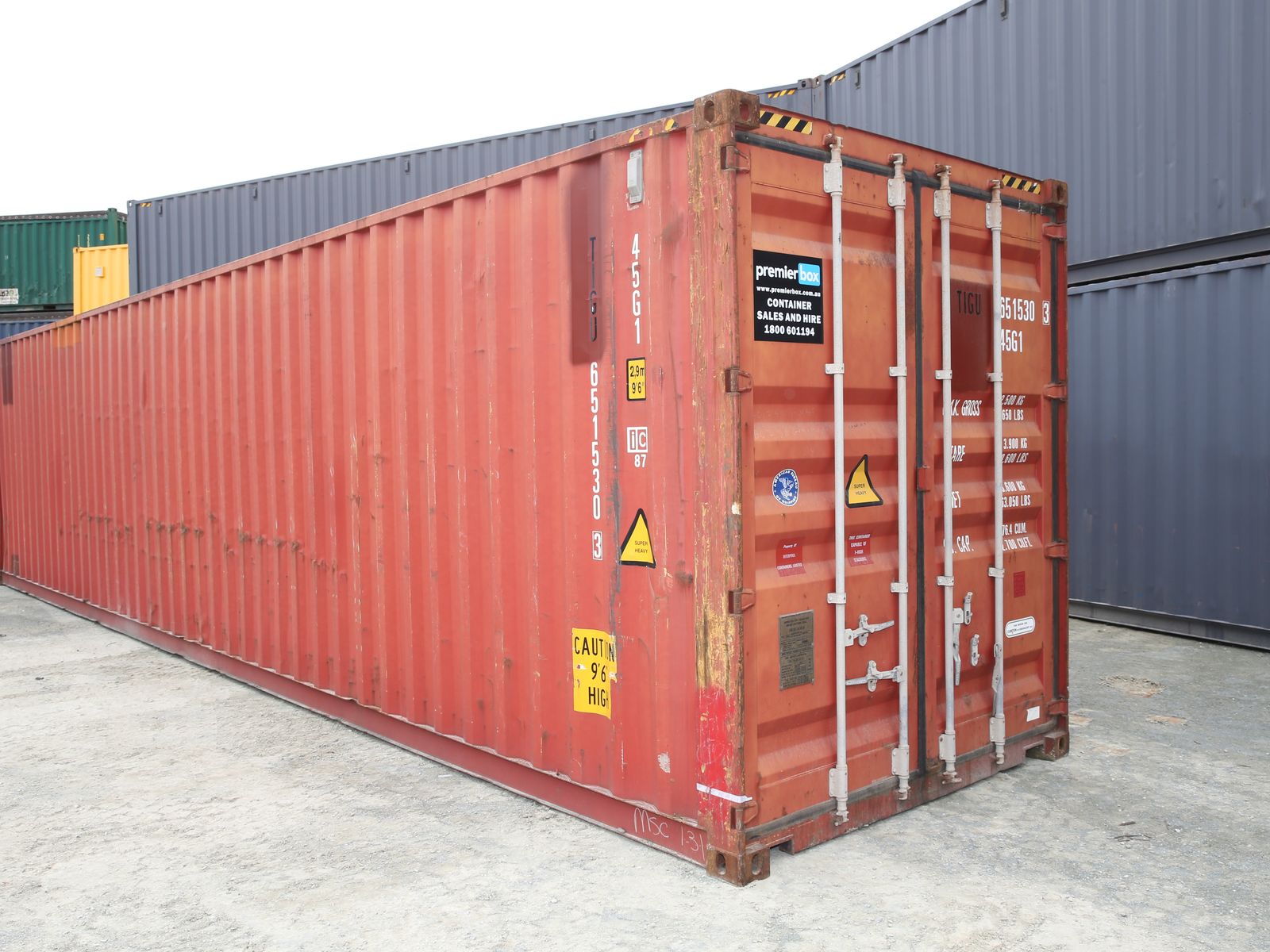 Red 40ft high cube used shipping container in a container yard