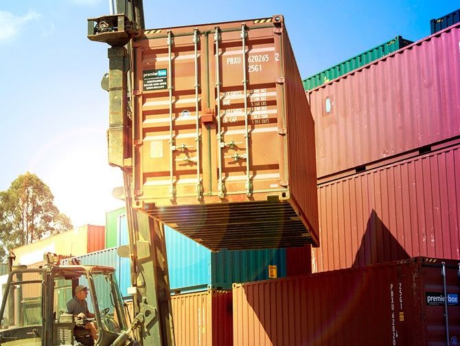 Stacked colourful shipping containers in a depot yard