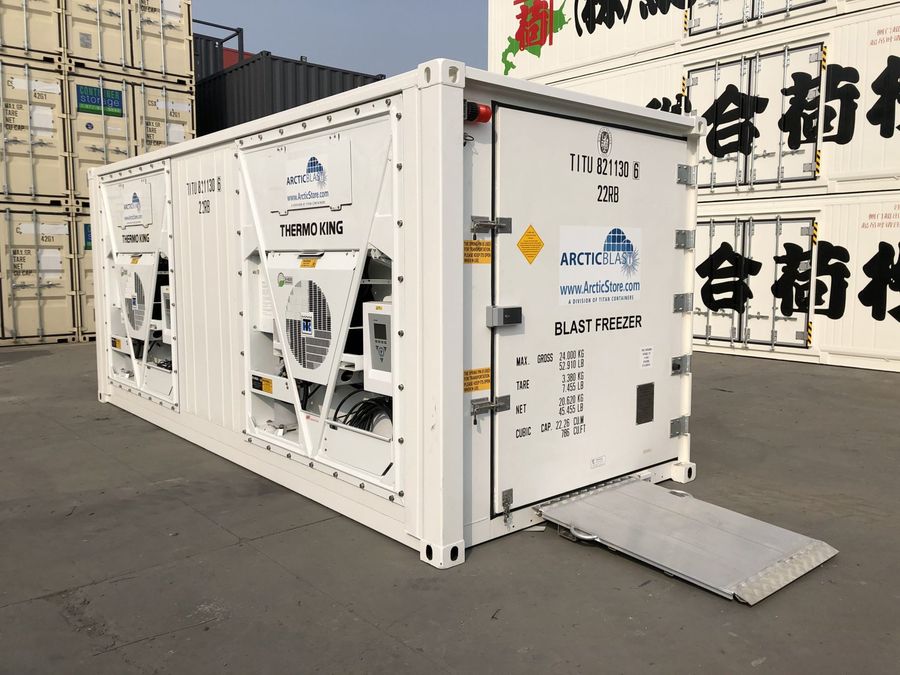 White ArcticStore refrigerated container with a loading ramp in a depot yard