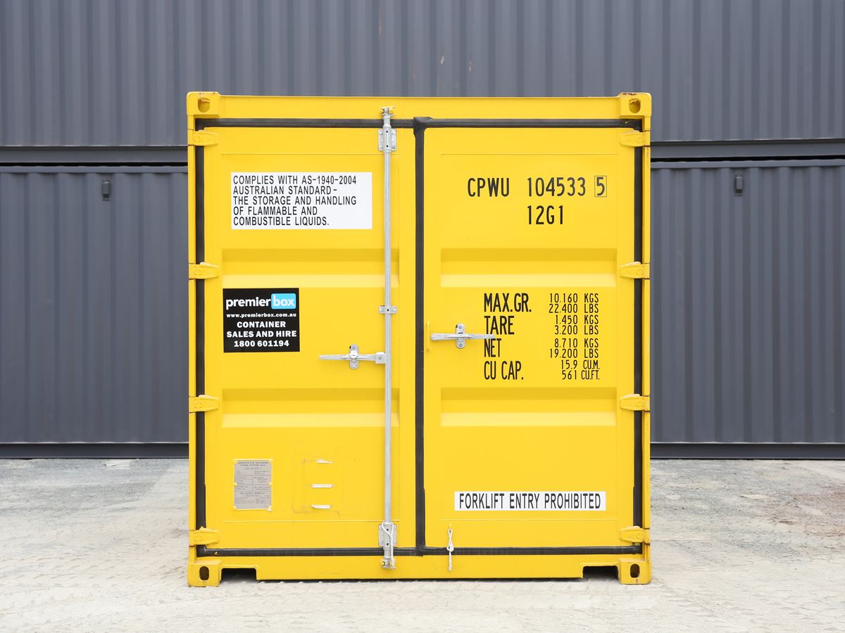 Yellow 10ft dangerous goods container with compliance labels on the doors