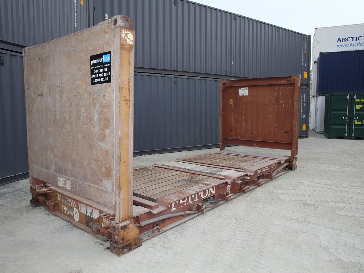 Flat rack container with its end walls raised, showing the timber deck