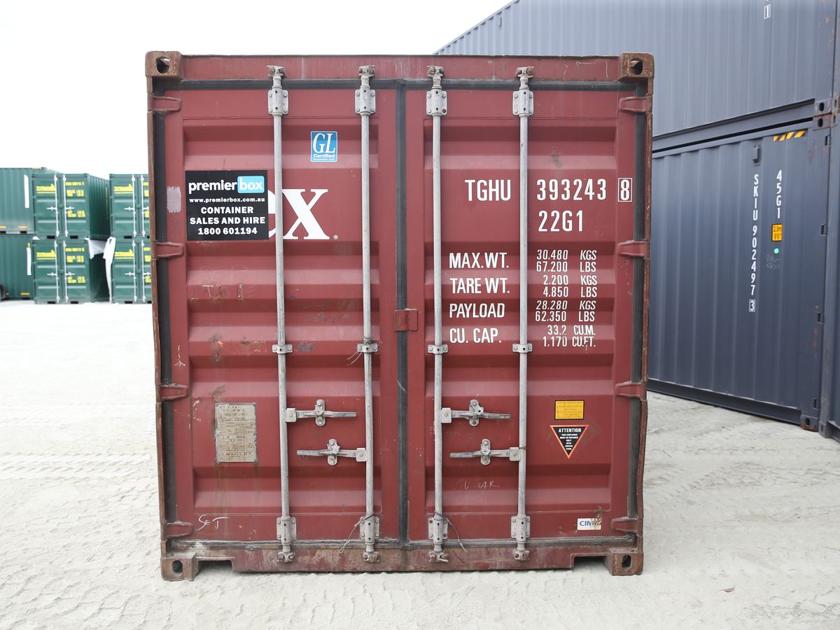 Maroon 20ft general purpose container with Premier Box sales sign on the doors