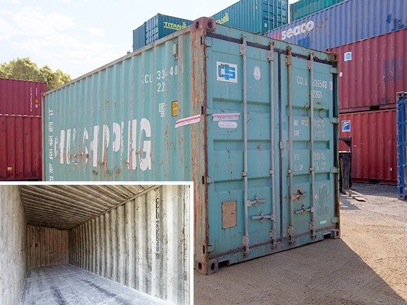 Heavily weathered teal industrial grade container with faded markings, with an inset of its worn interior