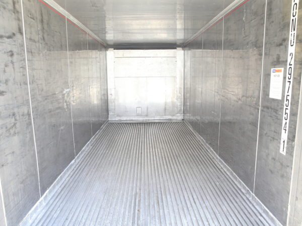 Empty refrigerated container interior with ribbed aluminium floor and walls