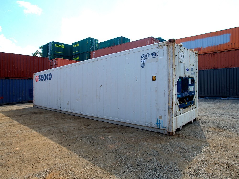 White 40ft Seaco operational refrigerated container with its refrigeration unit on the end wall, in the depot yard