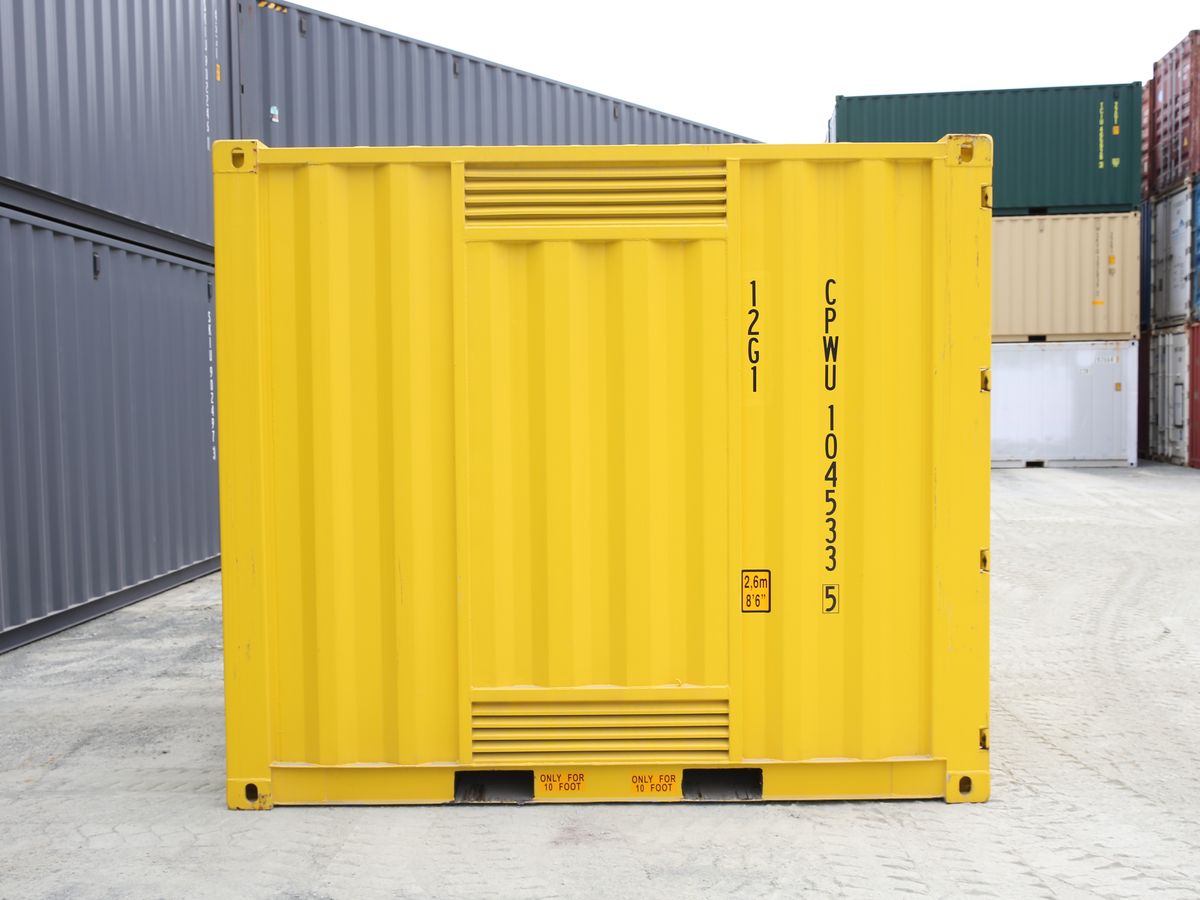Side of a yellow dangerous goods container showing its ventilation panels