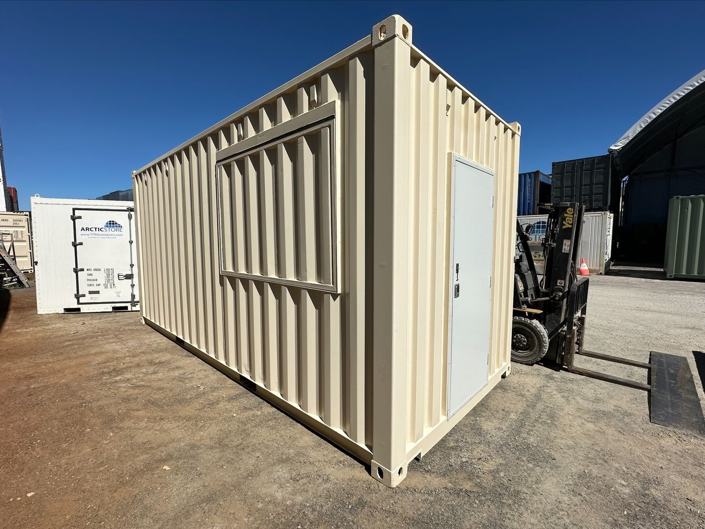 Cream 20ft container fitted with a PA door and a gas strut awning window