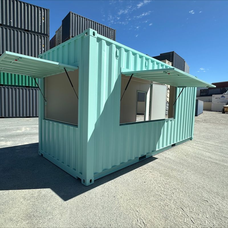 Turquoise container kiosk with two awning windows propped open