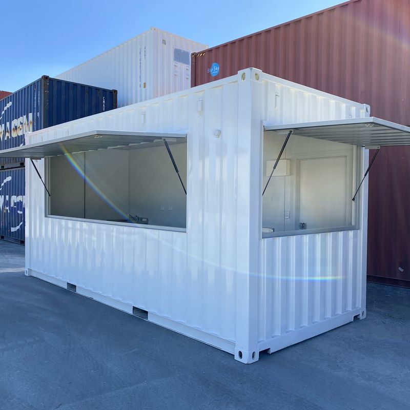 White container kiosk with servery windows and gas strut awnings
