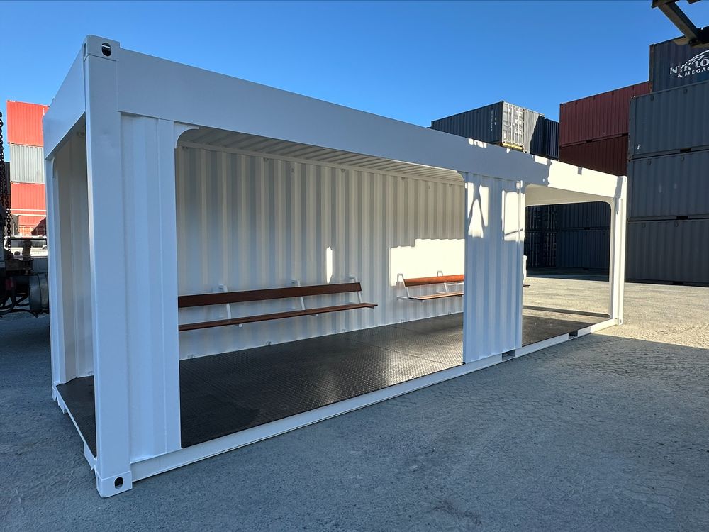 White container converted into an open bus shelter with bench seating