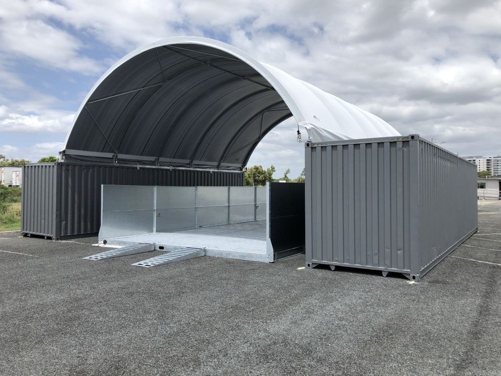 Two grey containers joined by a large dome shelter roof