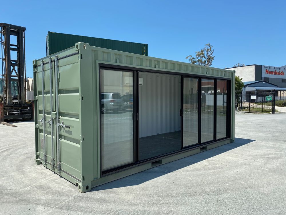 Sage green container room with full-length glass sliding doors