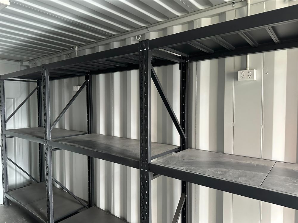 Heavy-duty steel shelving installed inside a 20ft container