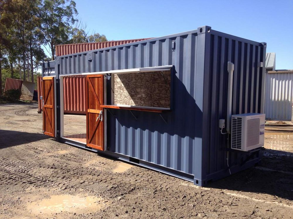 Navy container café with timber servery shutters open