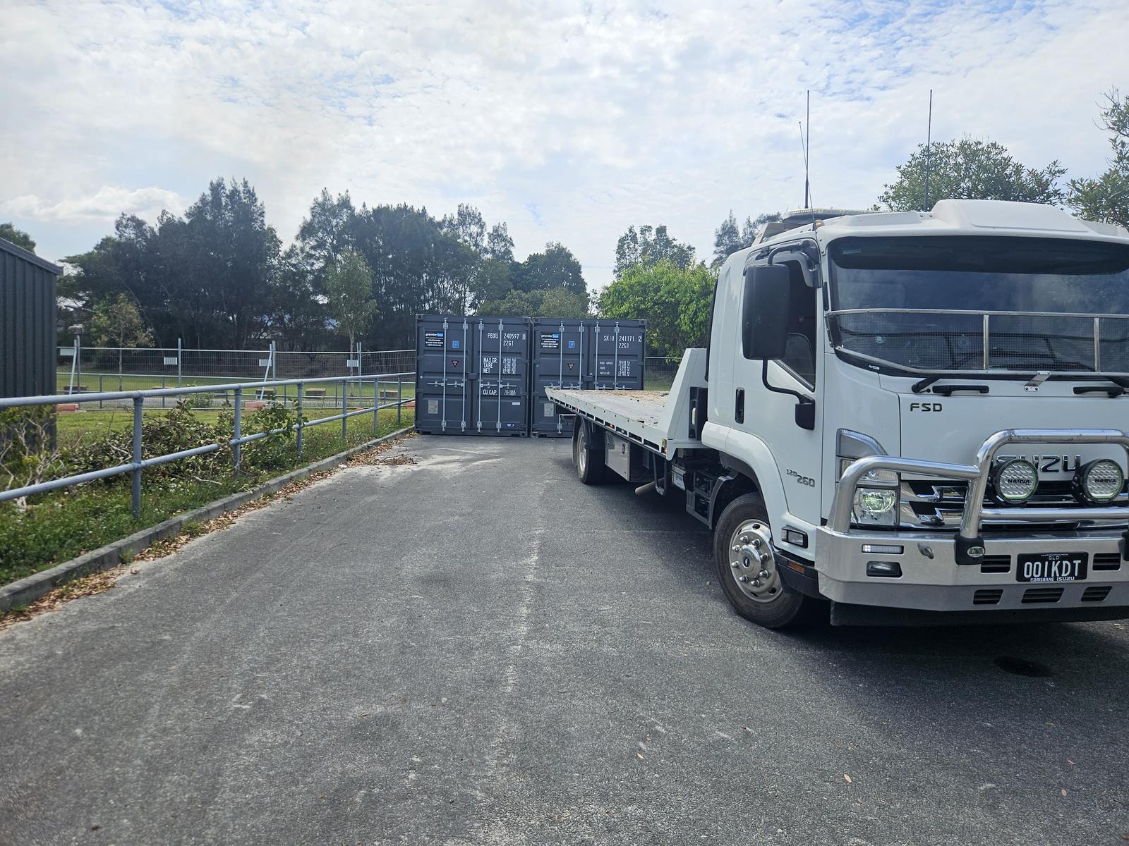 Hire containers loaded on a tilt tray delivery truck